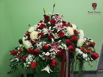 Lilies and Red Roses funeral flowers casket